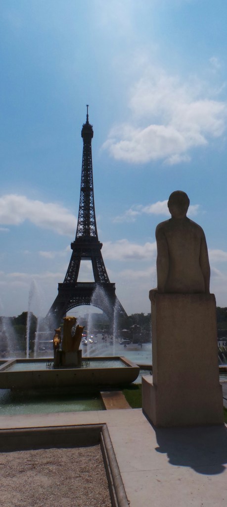 Statue looks out at the Eiffel Tower